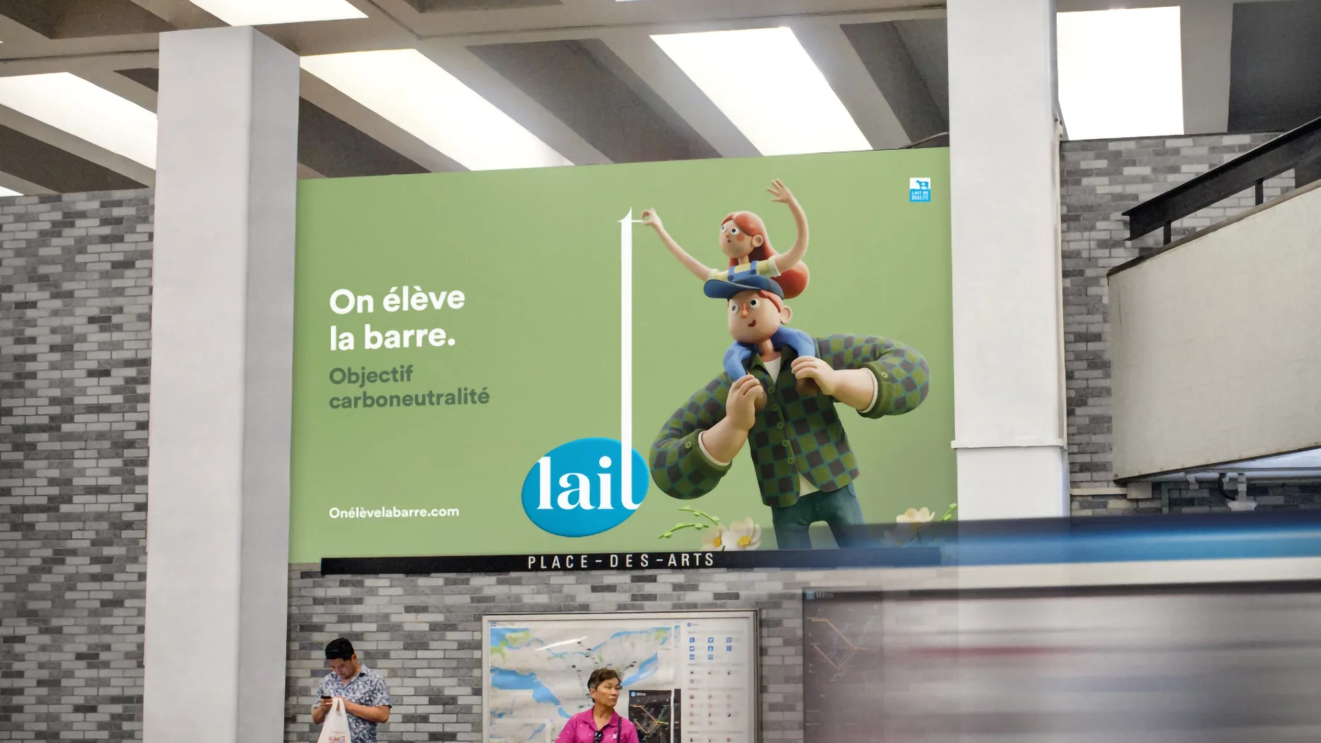 Place-des-Arts metro station ad: a clay farmer carrying a child on his shoulders